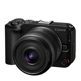 Cámara profesional Canon R50 V negra con lente RF-S 14-30mm, vista frontal sobre fondo blanco.